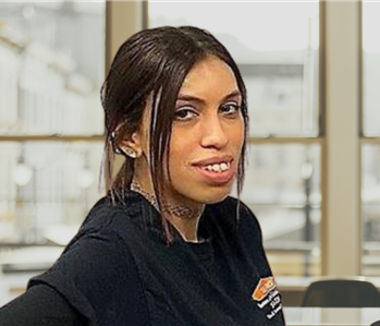 woman with long brown hair and servpro shirt on