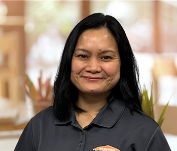 close mouthed woman with a black servpro shirt on