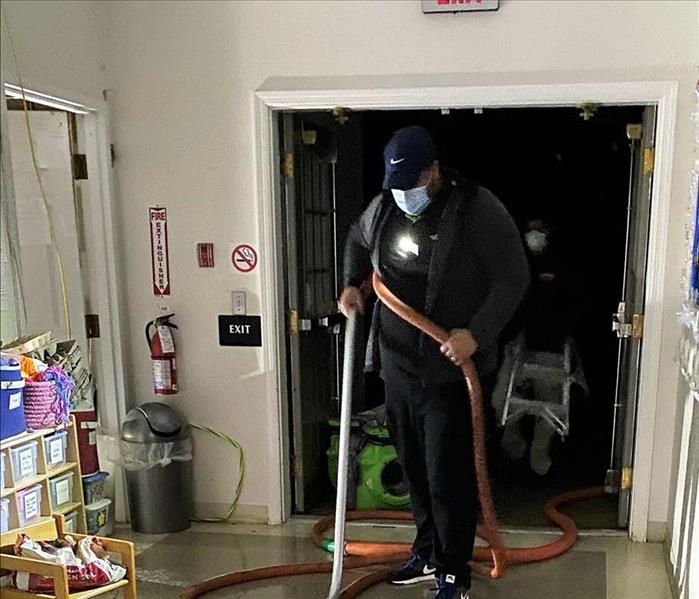 man cleaning a hallway
