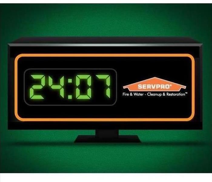 Digital clock with servpro logo with time at 24:07